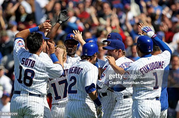 Geovaney Soto, Mike Fontenot, Ryan Theriot, Ryan Dempster and Kosuke Fukudome of the Chicago Cubs greet teammate Alfonso Soriano after Soriano drove...