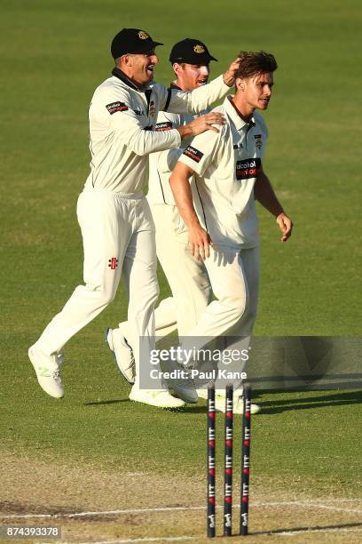 Shaun Marsh and Will Bosisto of Western Australia congratulate Andrew Holder after dismissing John Dalton of South Australia during day three of the...