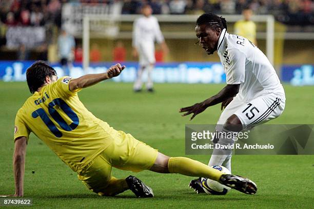 Royston Drenthe of Real Madrid is tackled by Cani of Villarreal during the La Liga match between Villarreal C.F. And Real Madrid at El Madrigal...