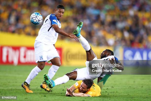 Bryan Acosta of Honduras and Johnny Palacios of Honduras tackle Mark Milligan of Australia during the 2018 FIFA World Cup Qualifiers Leg 2 match...