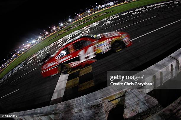 Tony Stewart, driver of the Office Depot Chevrolet, crosses the finish line to win the NASCAR Sprint All-Star Race on May 16, 2009 at Lowe's Motor...