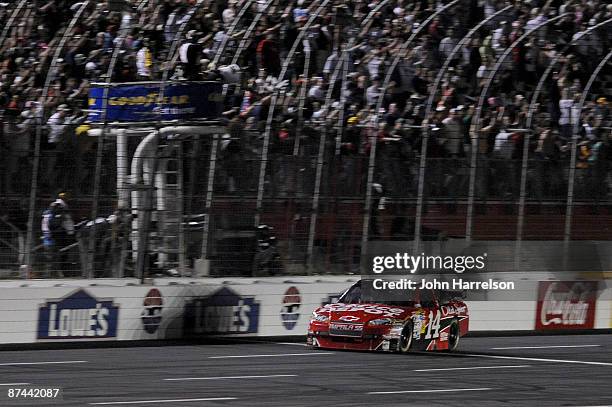 Tony Stewart driver of the Office Depot/Old Spice Chevrolet, takes the checkered flag to win the NASCAR Sprint All-Star Race on May 16, 2009 at...