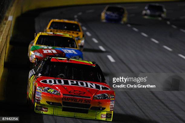 Jeff Gordon, driver of the DuPont Chevrolet leads a pack of cars during the NASCAR Sprint All-Star Race on May 16, 2009 at Lowe's Motor Speedway in...