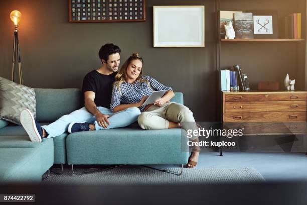 what shall we look for today? - couple with ipad in home stock pictures, royalty-free photos & images
