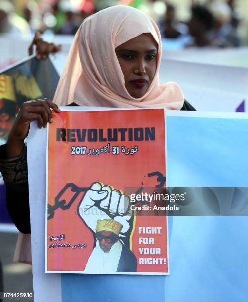 An Eritrean woman holds a banner reading "Revolution - Fight For Your Right" during a protest for religious freedom at African Union Headquarters in...