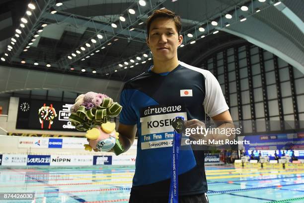 Yasuhiro Koseki of Japan poses for a photograph during the victory ceremony on day two of the FINA Swimming World Cup at Tokyo Tatsumi International...