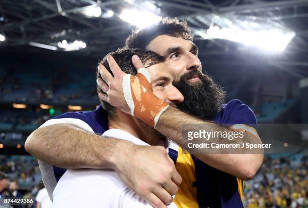 Mile Jedinak of Australia and James Troisi of Australia celebrate after winning the 2018 FIFA World Cup Qualifiers Leg 2 match between the Australian...