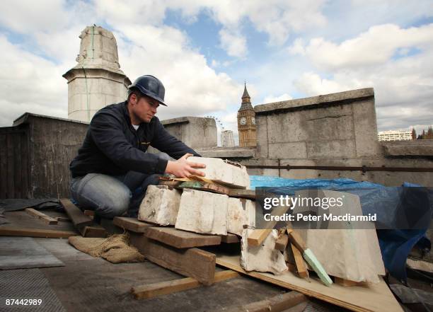 Stone Mason Mark Croll inspects the damaged remains of a stone pinacle on the bell tower roof of St. Margaret's Church on May 15, 2009 in London. St....