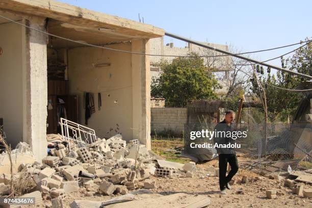 People gather around the blast site after an Assad regime's airstrike over residential areas in the de-escalation zone of Arbin town of the Eastern...