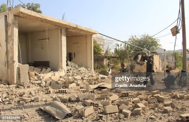 People gather around the blast site after an Assad regime's airstrike over residential areas in the de-escalation zone of Arbin town of the Eastern...