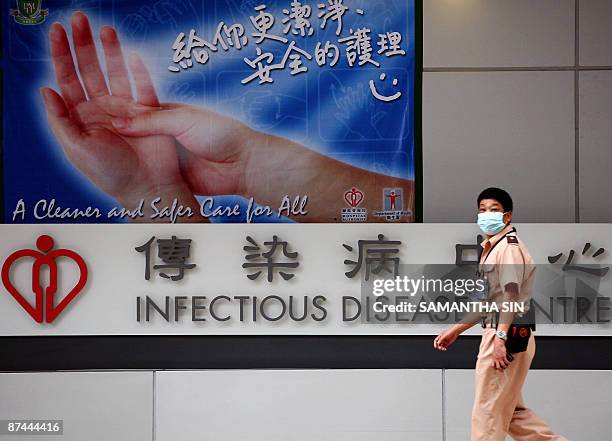 Hospital guard wears a mask as he walks past the the infectious disease centre at the Princess Margaret Hospital in Hong Kong on May 17, 2009. Hong...