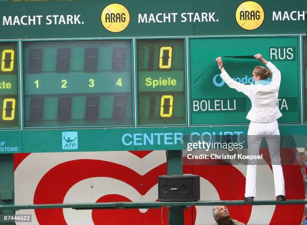 Volunteer changes the names of the score board during day one of the ARAG World Team Cup at the Rochusclub on May 17, 2009 in Duesseldorf, Germany.