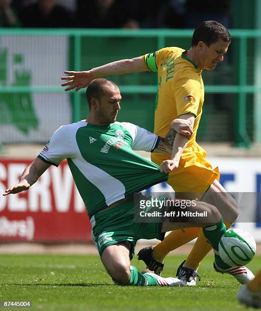 Steven Fletcher of Hibernian tackles Gary Caldwell of Celtic during the Scottish Premier League match between Hibernian and Celtic at Easter Road on...