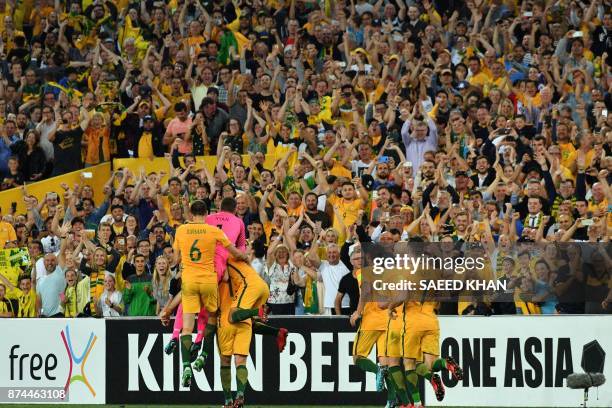 Australia's players celebrate after Mile Jedinak scored against Honduras in their 2018 World Cup qualification play-off football match at Stadium...
