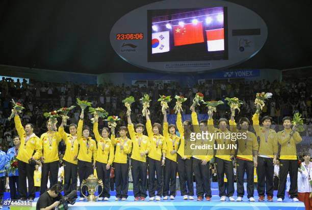 Members of China's badminton team cheer on the podium at the Sudirman Cup world badminton championships at the Guangzhou Gymnasium in China's...