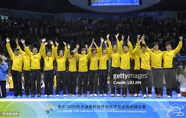 Members of China's badminton team acknowledge spectators on the podium at the Sudirman Cup world badminton championships at the Guangzhou Gymnasium...