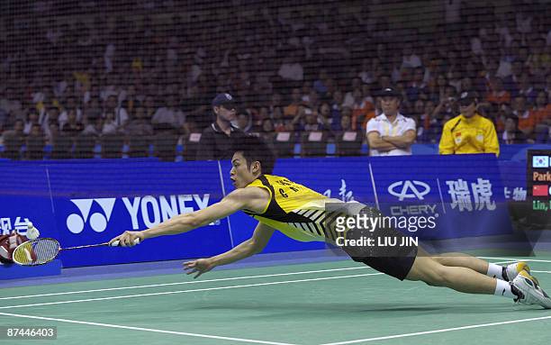 China's Lin Dan dives to reach a shuttlecock against South Korea's Park Sung Hwan during the men's singles final match at the Sudirman Cup world...
