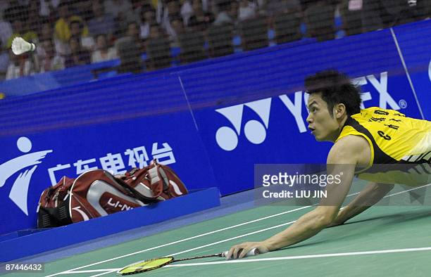 China's Lin Dan eyes a shuttlecock as he dives to return a shot against South Korea's Park Sung Hwan during the men's singles final match at the...