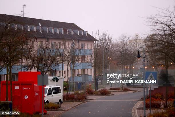 Policemen stand in front of a house of a reception centre for asylum seekers in Bamberg, southern Germany, on early November 15, 2017. A man was...