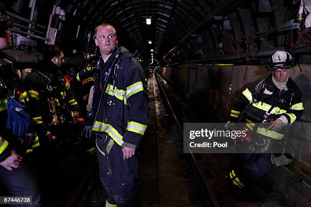 Emergency responders stand underground on the train tracks during an emergency drill staged near the World Trade Center site on May 17, 2009 in New...