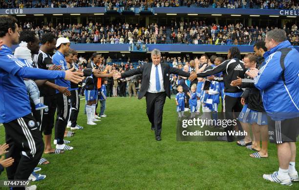 Chelsea Manager Guus Hiddink is given a guard of honour by his players and staff after the Barclays Premier League match between Chelsea and...