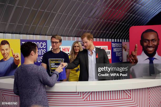Prince Harry gives a HIV self-test kit to a local resident during his visit to the opening of the Terrence Higgins Trust charity's HIV self-test...