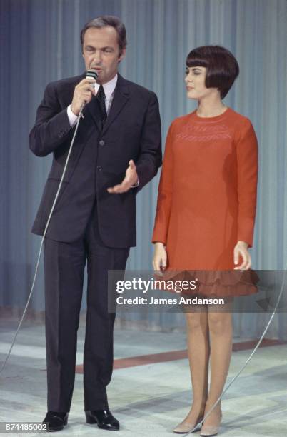 French singer Mireille Mathieu on stage with tv host Guy Lux, Paris 9th october 1968
