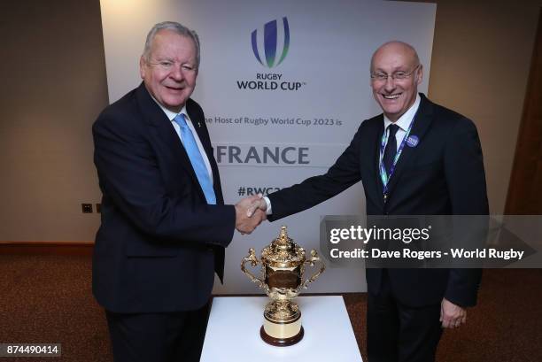 Bill Beaumont, the World Rugby via Getty Images chairman, shakes hands with FFR President Bernard Laporte after the annoucement that France will host...