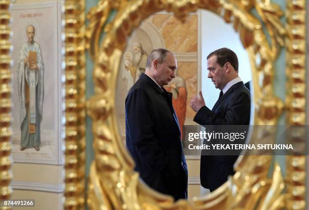 Russian President Vladimir Putin and Prime Minister Dmitry Medvedev visit the New Jerusalem Orthodox Monastery outside the town of Istra, some 70 km...