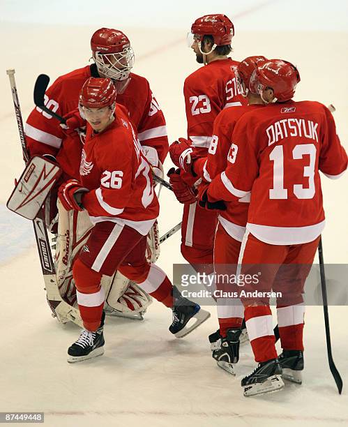 Goalie Chris Osgood of the Detroit Red Wings celebrates with his teammates after their 5-2 win against the Chicago Blackhawks during Game One of the...