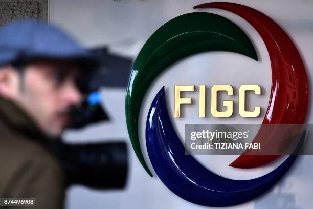 Journalists work outside the Italian Football Federation headquarters as they wait for the arrival of FIGC President Carlo Tavecchio on November 15...