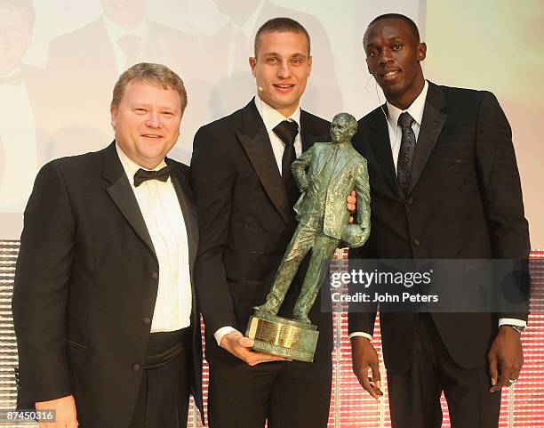 Nemanja Vidic of Manchester United poses with Olympic Champion Usain Bolt and the Sir Matt Busby Fans' Player of the Year Award at the club's annual...