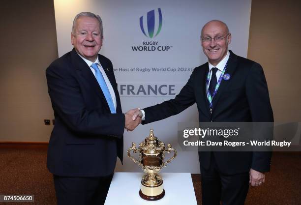 Bill Beaumont, the World Rugby via Getty Images chairman, congratulates FFR President Bernard Laporte after the annoucement that France will host...