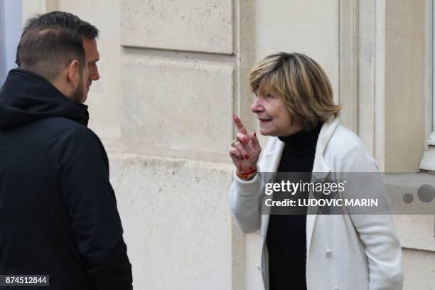 Head of Bestimage photo agency Michele Marchand gestures as she speaks with people in the courtyard of of the Elysee Palace in Paris on November 15,...