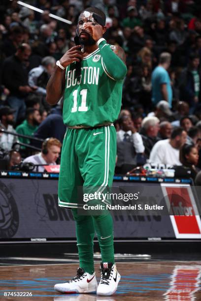 Kyrie Irving of the Boston Celtics fixes his mask during the game against the Brooklyn Nets on November 14, 2017 at Barclays Center in Brooklyn, New...