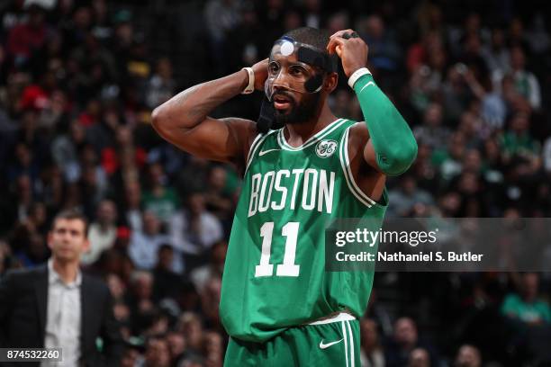 Kyrie Irving of the Boston Celtics fixes his mask during the game against the Brooklyn Nets on November 14, 2017 at Barclays Center in Brooklyn, New...