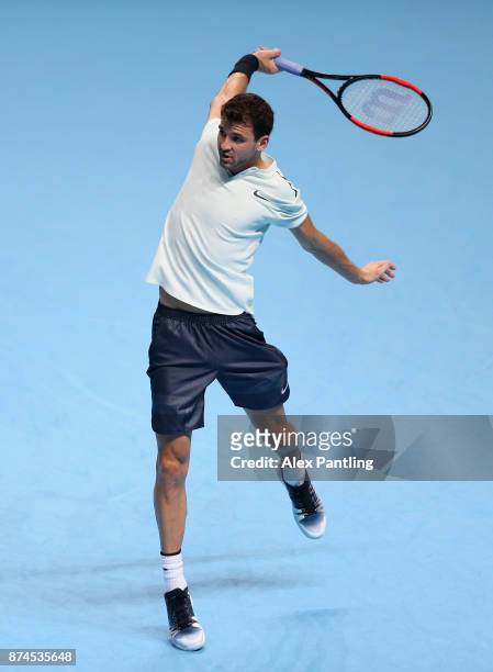 Grigor Dimitrov of Bulgaria returns the ball during the singles match against David Goffin of Belgium on day four of the 2017 Nitto ATP World Tour...
