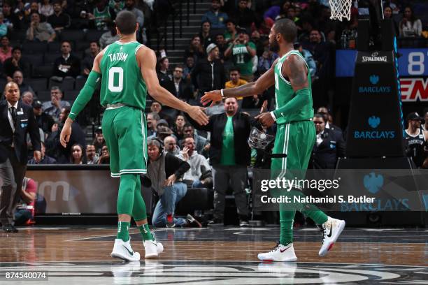 Jayson Tatum and Kyrie Irving of the Boston Celtics shake hands during the game against the Brooklyn Nets on November 14, 2017 at Barclays Center in...