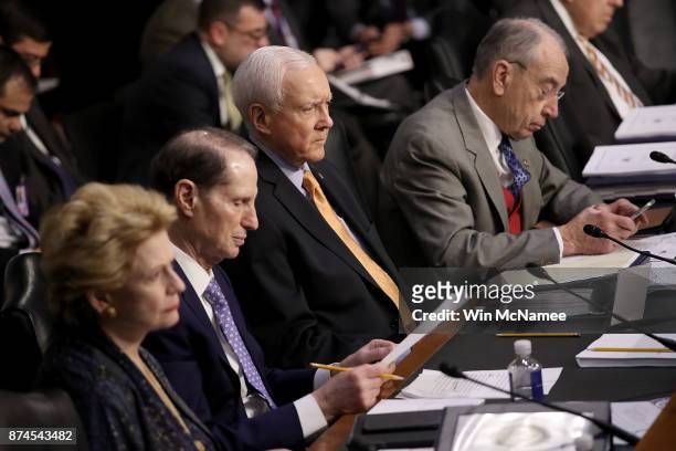 Senate Finance Committee chairman Orrin Hatch and ranking member Sen. Ron Wyden listen to testimony during a markup by the committee of the...
