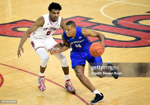 Bryson Robinson of New Orleans is defended by Justin Simon of St. John's during an NCAA basketball game at Carnesecca Arena on November 10, 2017 in...