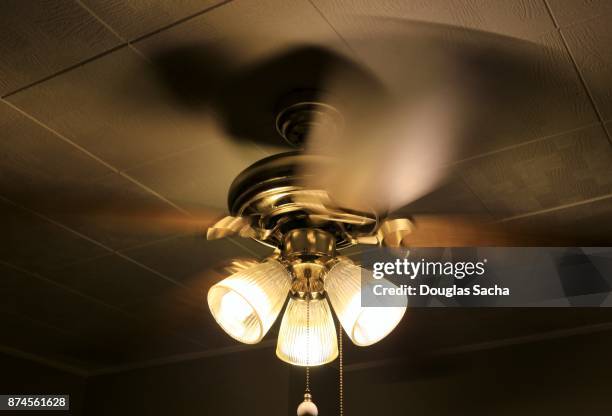 overhead spinning ceiling fan with illuminated lights - 40ワットクラブ ストックフォトと画像