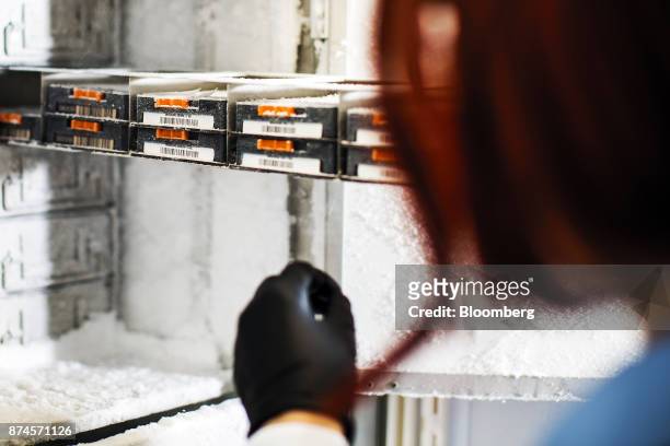 Research associate opens a freezer at the Moderna Therapeutics Inc. Lab in Cambridge, Massachusetts, U.S., on Tuesday, Nov. 14, 2017. Moderna this...