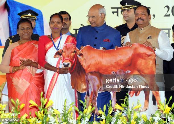 President Ram Nath Kovind giving cheaque to a beneficiary of dairy project during the 17th Foundation Day function of Jharkhand state at Morhabadi...