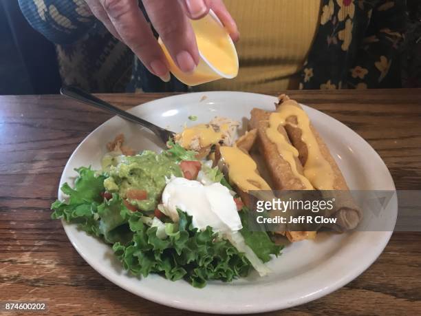 cheese sauce and chicken flautas in texas - flauta stock-fotos und bilder