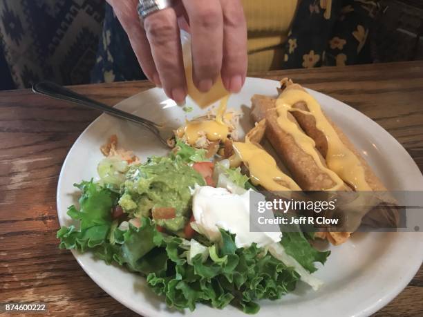 cheese sauce and chicken flautas in texas 2 - flauta stock-fotos und bilder