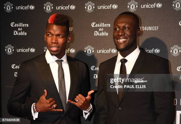 Manchester United's French midfielder Paul Pogba and British grime and hip hop artist Stormzy pose on the red carpet as they arrive to attend the...