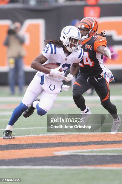 Hilton of the Indianapolis Colts runs the football upfield against Adam Jones of the Cincinnati Bengals during their game at Paul Brown Stadium on...