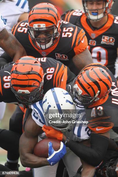 Vontaze Burfict, Carlos Dunlap and George Iloka of the Cincinnati Bengals make the tackle on Frank Gore of the Indianapolis Colts during their game...