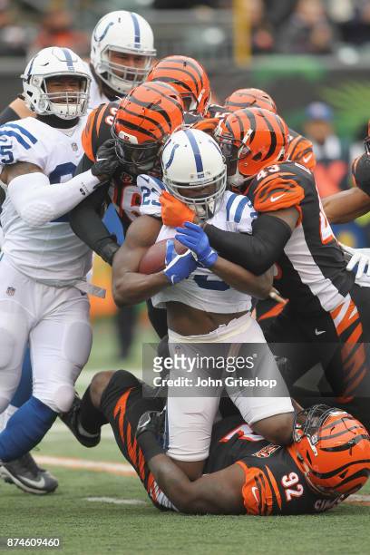 Vontaze Burfict, Carlos Dunlap and George Iloka of the Cincinnati Bengals make the tackle on Frank Gore of the Indianapolis Colts during their game...