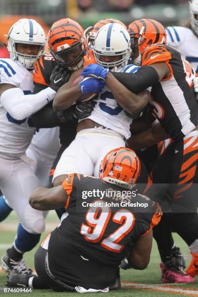 Carlos Dunlap and George Iloka of the Cincinnati Bengals make the tackle on Frank Gore of the Indianapolis Colts during their game at Paul Brown...